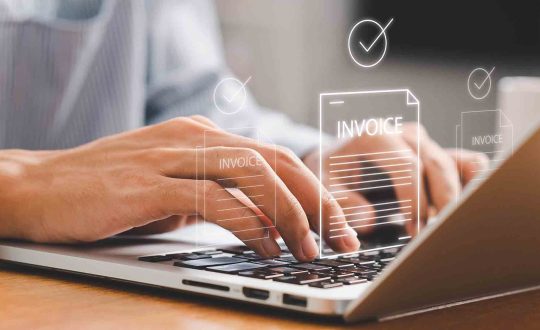 Businessman,Using,Laptop,To,Manage,Digital,Invoices,And,Billing.,Concept