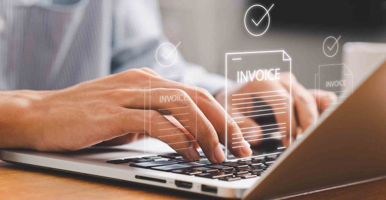 Businessman,Using,Laptop,To,Manage,Digital,Invoices,And,Billing.,Concept